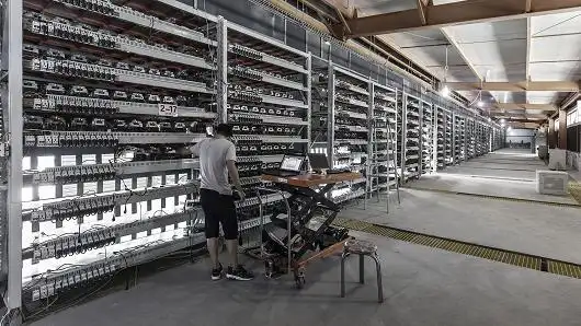 Large-scale cryptocurrency mining farm with rows of mining rigs in a controlled environment